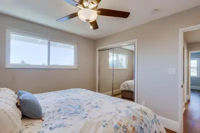 a bedroom with a bed and a ceiling fan at Destination #44 in Orange