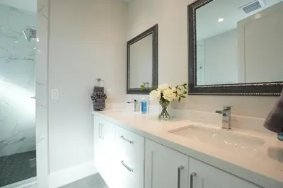 a white bathroom with a sink and a mirror at Destination #45 in Orange