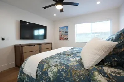 a bedroom with a bed and a flat screen tv at Destination #45 in Orange