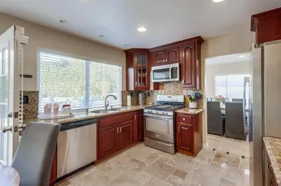 a kitchen with wooden cabinets and a stainless steel appliances at Destination #48 in Placentia