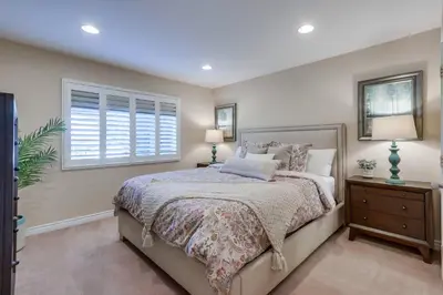 a bedroom with a large bed and a window at Destination #48 in Placentia