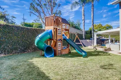 a playground with a slide in a yard at Destination #48 in Placentia