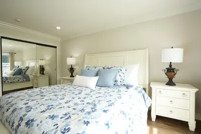 a bedroom with a large bed with blue flowers at Destination #01 in Anaheim
