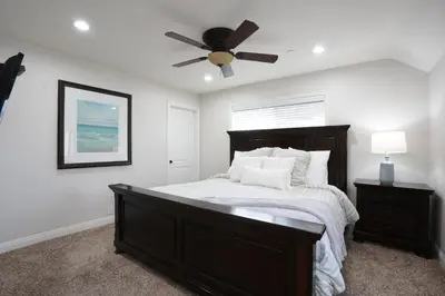 a bedroom with a bed with a ceiling fan at Destination #01 in Anaheim