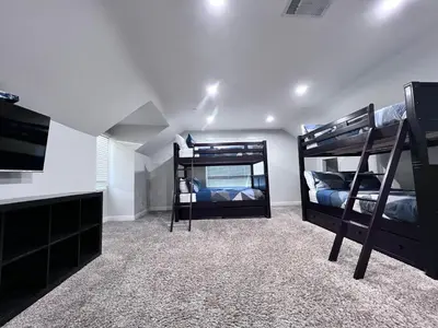 a bedroom with two bunk beds and a tv at Destination #01 in Anaheim