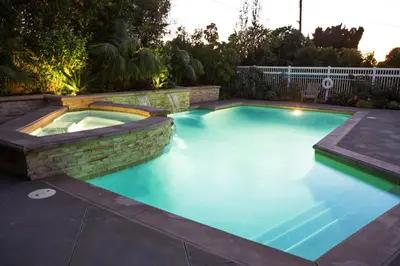 a swimming pool in a backyard with a brick wall at Destination #01 in Anaheim