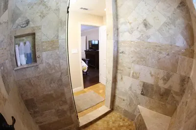 a walk in shower with a glass door in a bathroom at Destination #14 in Anaheim
