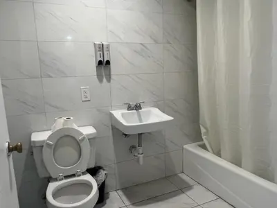 a bathroom with a toilet and a sink at Pomona Inn in Pomona