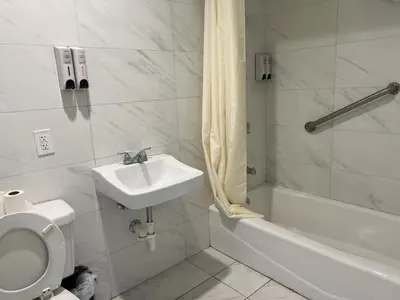 a bathroom with a sink and a toilet and a tub at Pomona Inn in Pomona