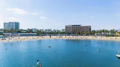 a beach with a bunch of people in the water at The Blossom-Modern 1BR Getaway in Marina Walk to Water&Restaurants in Los Angeles