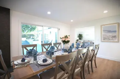 a dining room with a long table and chairs at Destination #47 in Orange