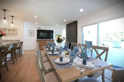 a dining room with a long wooden table with chairs at Destination #47 in Orange