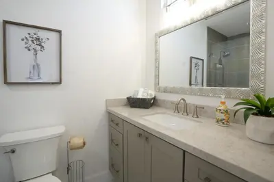 a bathroom with a sink and a toilet and a mirror at Destination #47 in Orange