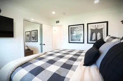 a bedroom with a black and white checkered bed at Destination #47 in Orange