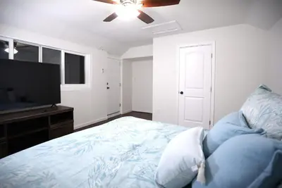 a bedroom with a bed and a flat screen tv at Destination #51 in Santa Ana