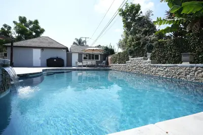 a swimming pool with blue water in a house at Destination #51 in Santa Ana