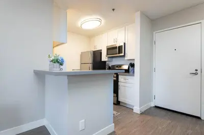 a kitchen with white cabinets and a counter top at Hollywood 1Bed Apt w Rooftop pool & Panoramic View in Los Angeles