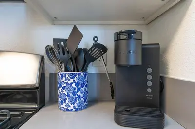 a kitchen counter with a blender and a cup of utensils at Hollywood 1Bed Apt w Rooftop pool & Panoramic View in Los Angeles