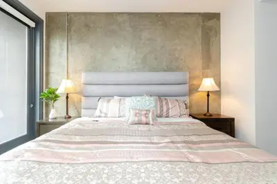 a bedroom with a large bed with two lamps at Cozy 3bed Condo with balcony & a rooftop pool in Los Angeles