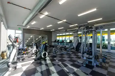 a gym with treadmills and machines in a room at Cozy 3bed Condo with balcony & a rooftop pool in Los Angeles