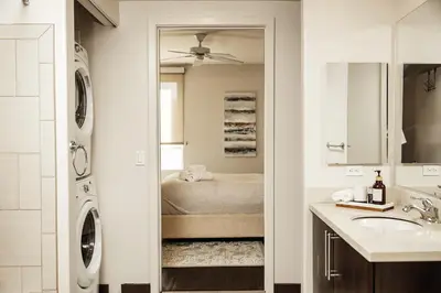 a bathroom with a sink and a washer and dryer at Beautiful Studio in West Hollywood in Los Angeles