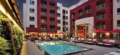 a hotel courtyard with a swimming pool in front of a building at Beautiful Studio in West Hollywood in Los Angeles