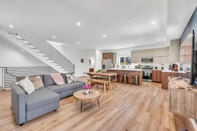 a living room with a couch and a table at Luxurious Townhome W/3 Master Suites gated Parking in Los Angeles