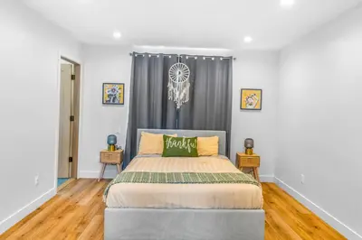 a bedroom with a bed and a window at Luxurious Townhome W/3 Master Suites gated Parking in Los Angeles
