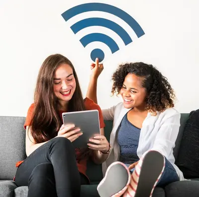 two women sitting on a couch looking at a tablet at Luxurious Townhome W/3 Master Suites gated Parking in Los Angeles