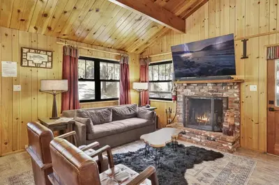 a living room with a couch and a fireplace at Bruin Chalet Big Bear~ Cozy Single Level Retreat Cottage~ in Big Bear Lake