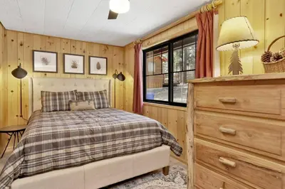 a bedroom with a bed and a dresser at Bruin Chalet Big Bear~ Cozy Single Level Retreat Cottage~ in Big Bear Lake