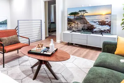 a living room with a couch and a table at Family Getaway Villa to Disneyland! Sleeps up to 22 persons w Game Room, Pool Table & EV Friendly in Midway City