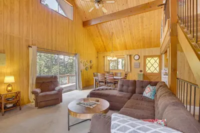 a living room with a couch and a table at Woodsy Lake Arrowhead Cabin with Fire Pit Table in Lake Arrowhead