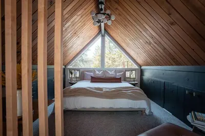 a bedroom with a bed in a wooden ceiling at Lightfoot Cabin Mid-Century Perfect Romantic Getaway Hot Tub Sauna in Running Springs