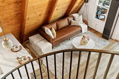 a living room with a couch and a table at The Scandia “A-Frame Chalet” Fireplace & Hot tub in Running Springs