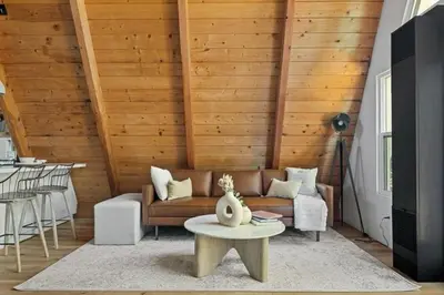 a living room with a couch and a table at The Scandia “A-Frame Chalet” Fireplace & Hot tub in Running Springs
