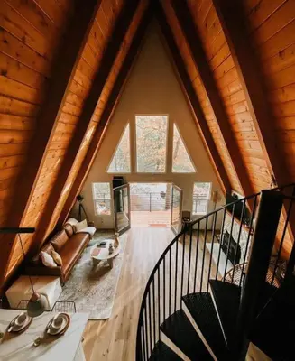 a living room with a large window in a house at The Scandia “A-Frame Chalet” Fireplace & Hot tub in Running Springs