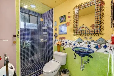 a bathroom with a shower and a toilet and a sink at The Malibu Retreat Private Compound w/ Salt Water Pool + Views in Malibu