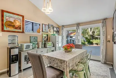 a kitchen with a table and chairs and a kitchen with a window at The Malibu Retreat Private Compound w/ Salt Water Pool + Views in Malibu