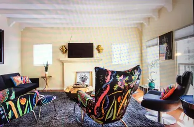 a living room with a couch and chairs and a tv at Luxury 2 Bedroom Suite Apartment in Koreatown in Los Angeles