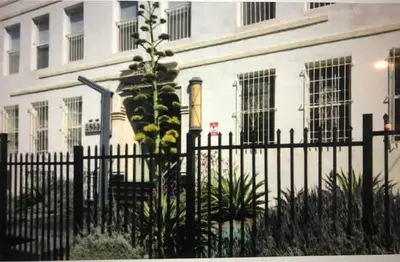 a black fence in front of a white building at Luxury 2 Bedroom Suite Apartment in Koreatown in Los Angeles