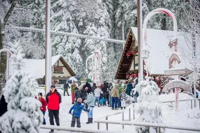 a group of people walking around a christmas market in the snow at Classic AFrame - Fireplace - GameRoom - 2 Decks View in Lake Arrowhead