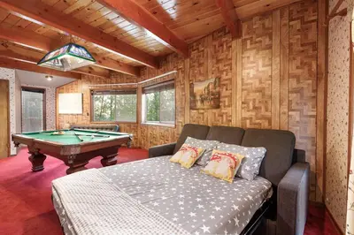 a room with a bed and a pool table at Classic AFrame - Fireplace - GameRoom - 2 Decks View in Lake Arrowhead