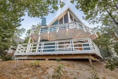 a large house on top of a hill at Classic AFrame - Fireplace - GameRoom - 2 Decks View in Lake Arrowhead