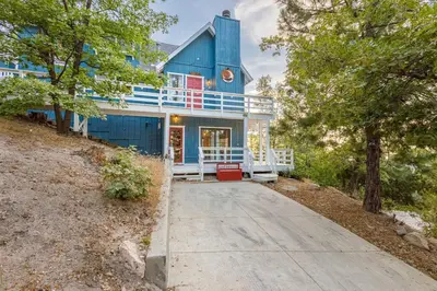 a blue house with a porch and a driveway at Classic AFrame - Fireplace - GameRoom - 2 Decks View in Lake Arrowhead
