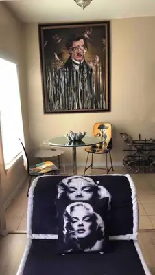 a room with a table and a picture of a man at Murano Studio in the Heart of Koreatown in Los Angeles