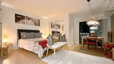a bedroom with a bed and a desk and a chair at Chic Retreat by Santa Monica in Los Angeles