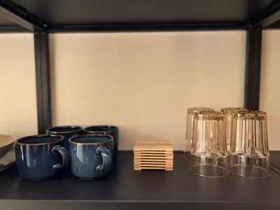 a group of cups and glasses on a shelf at Chic Retreat by Santa Monica in Los Angeles