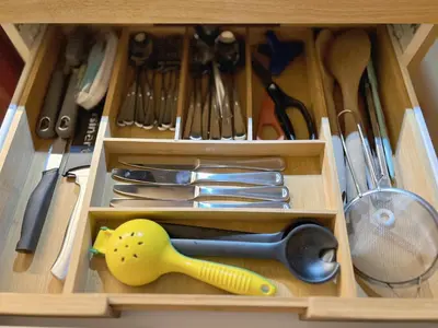 a wooden drawer filled with utensils in a kitchen at Chic Retreat by Santa Monica in Los Angeles