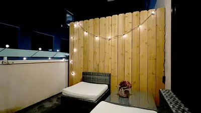 a room with a bench and a wooden wall with lights at Chic Retreat by Santa Monica in Los Angeles